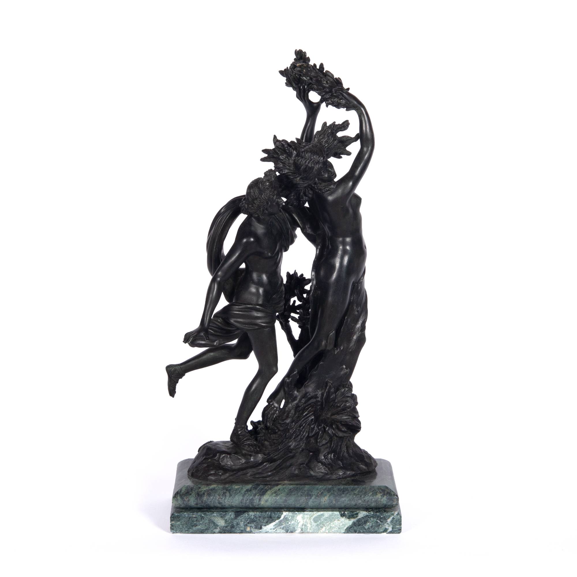 Bronze sculpture of two people swirled together with leaves and fabric.